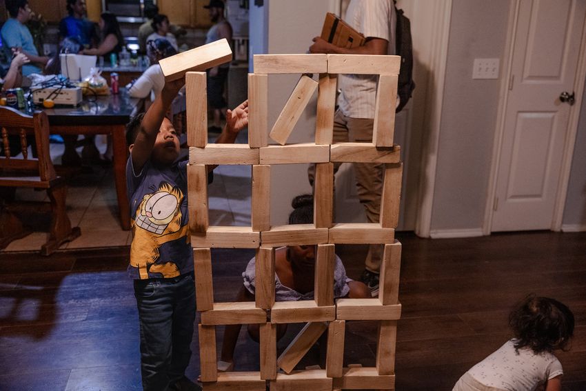 The Avila grandchildren make a Jenga version of the detention facility where their grandmother, Margarita, has been for over three months Saturday, May 24, 2025, in Houston.(Lexi Parra for The Texas Tribune)